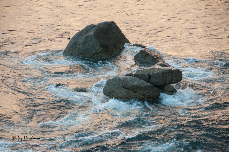 The sea swirls in cast opalescence.