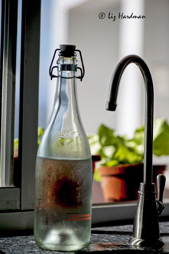 Spiget for filetered tap water and glass bottle.