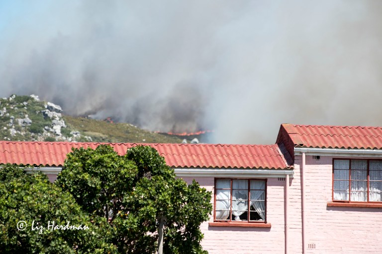 Flames pushing towards the houses.